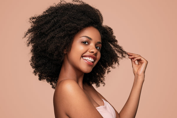 Smiling woman with  coily hair 