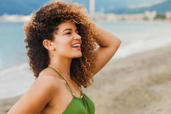 Woman with curly hair on the beach
