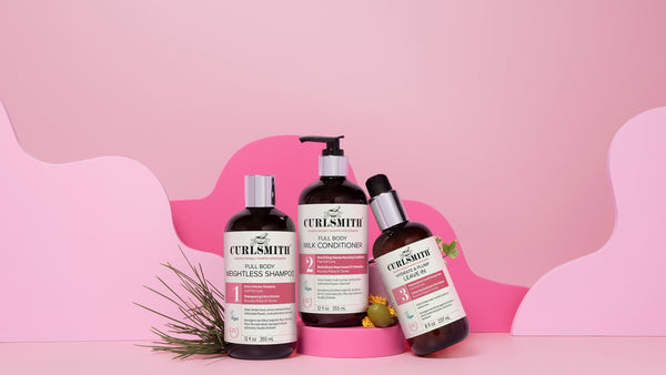 Three Curlsmith volumising hair products on a pink background