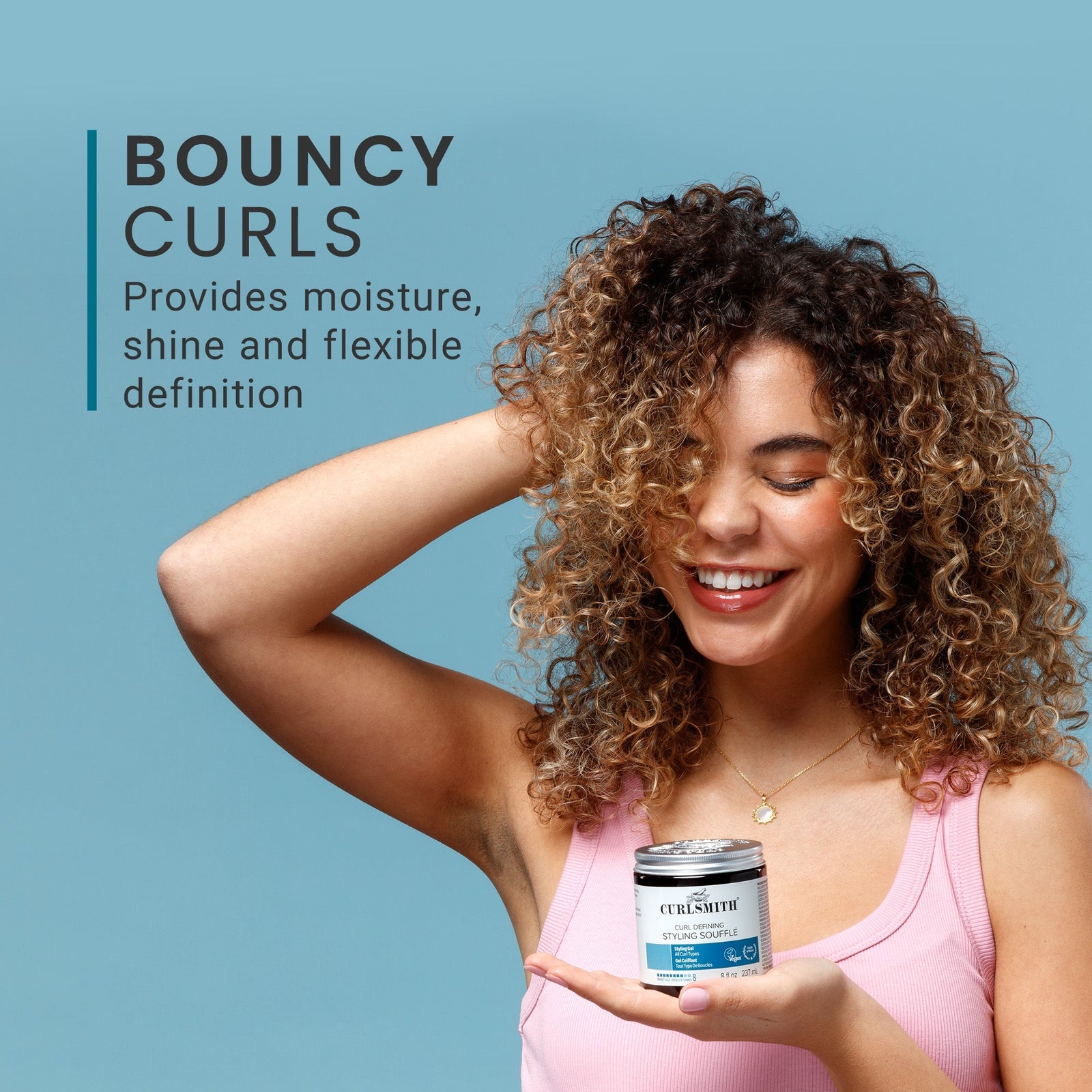 Woman with curly hair holding a product container against a blue background, with text about bouncy curls.