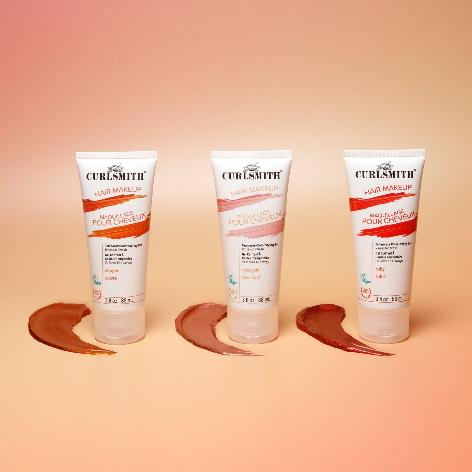 Three bottles of Curlsmith hair makeup on a peach background with hair product swatches.