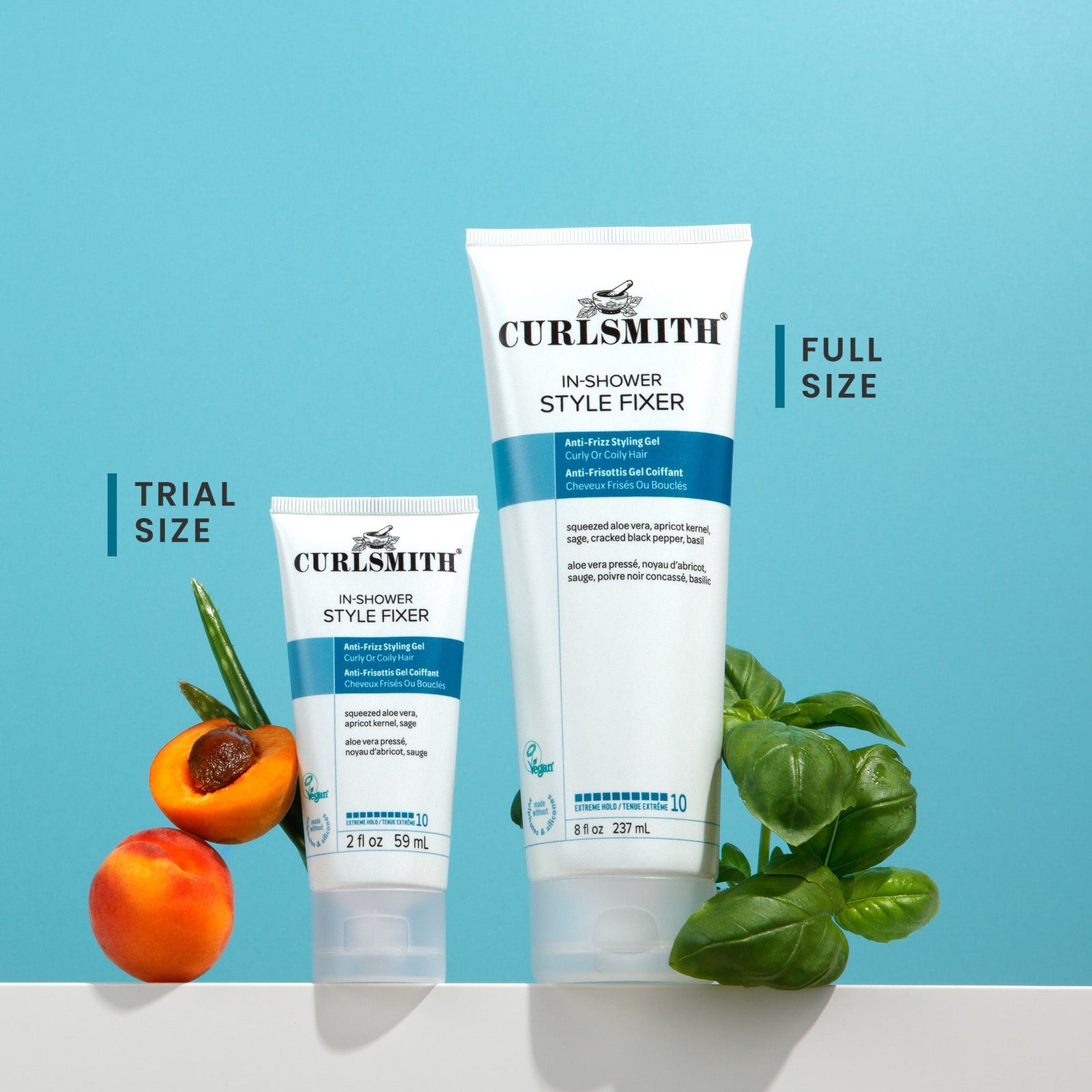 Two bottles of Curlsmith In-Shower Style Fixer with a peach and basil leaves on a blue background