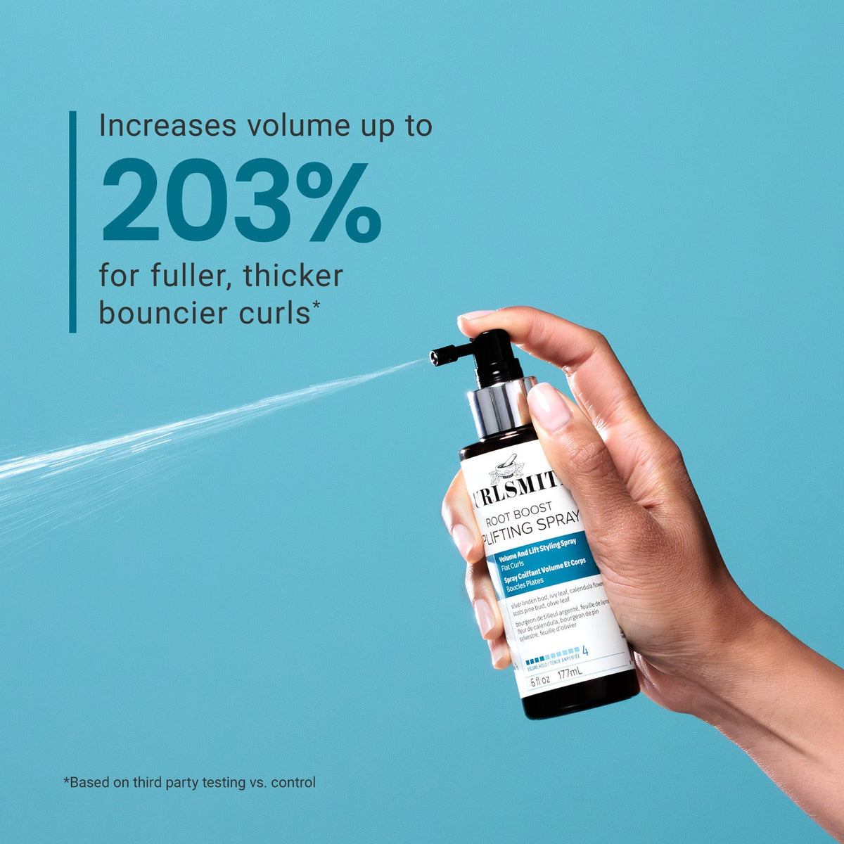 Hand holding a bottle of Ruskite Root Boost Texturizing Spray against a blue background