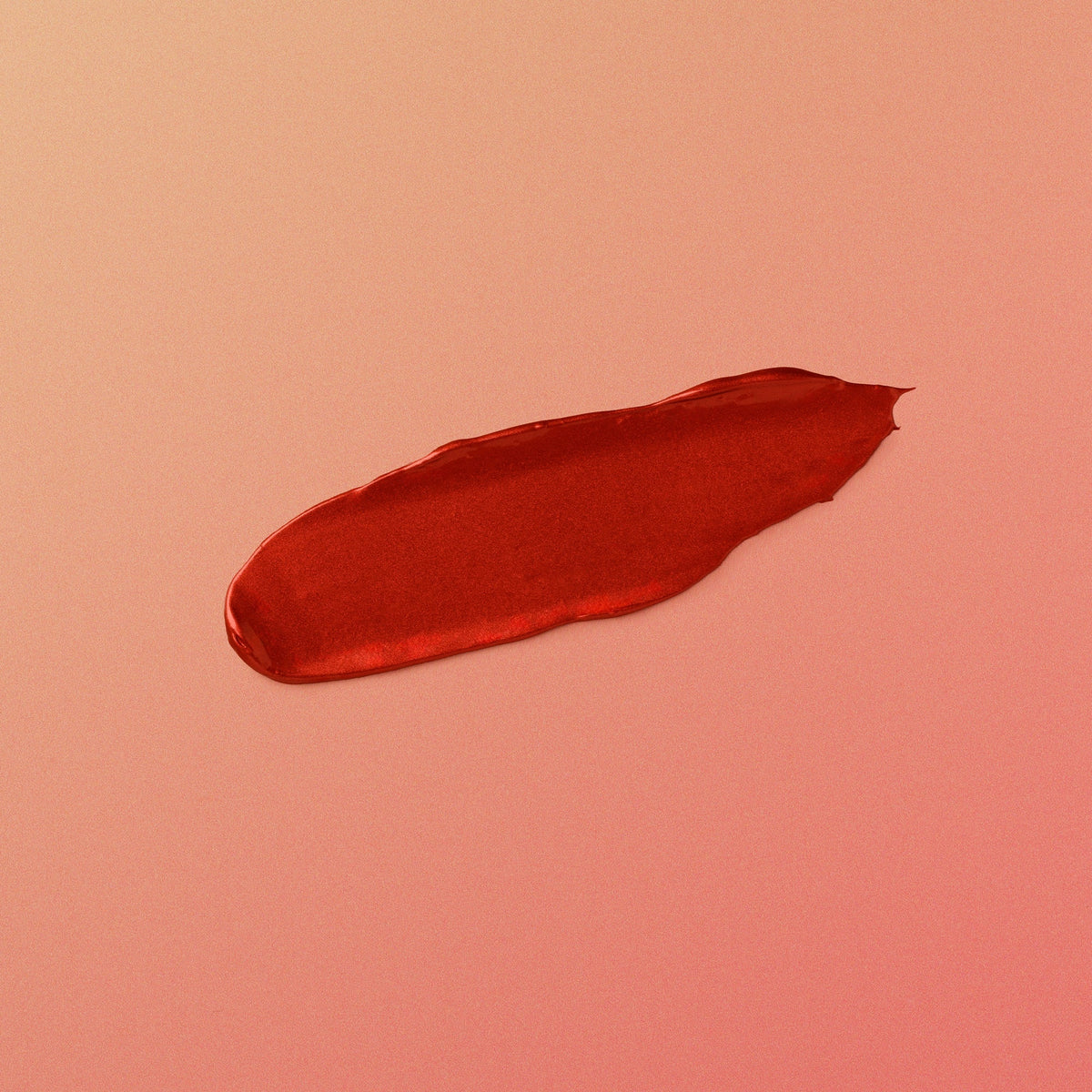 Red lipstick swatch on a pink background