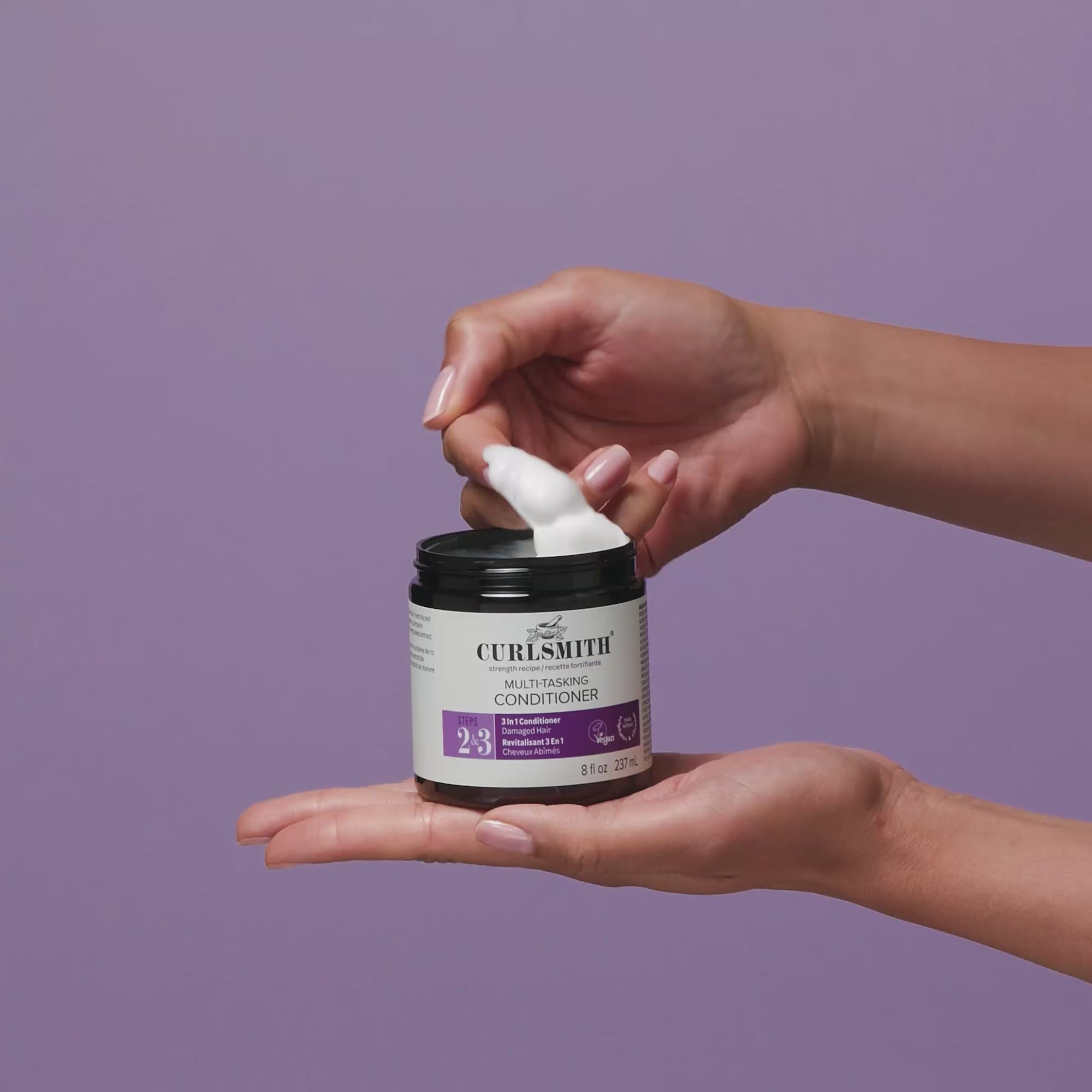 Person applying Curlsmith Multi-tasking Conditioner