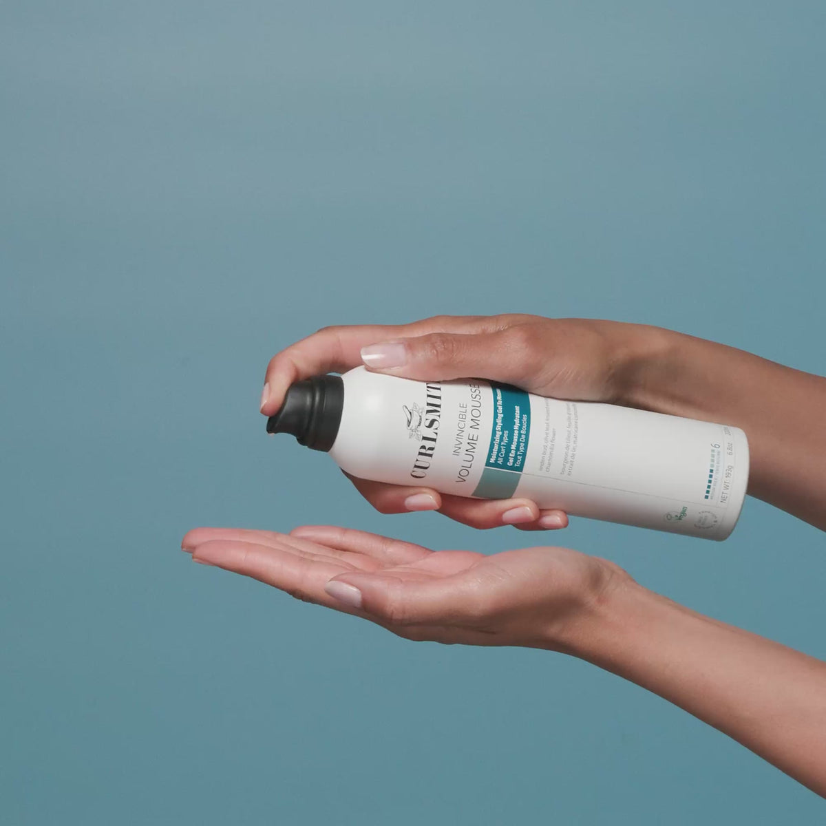 Person applying Curlsmith Volume Mousse