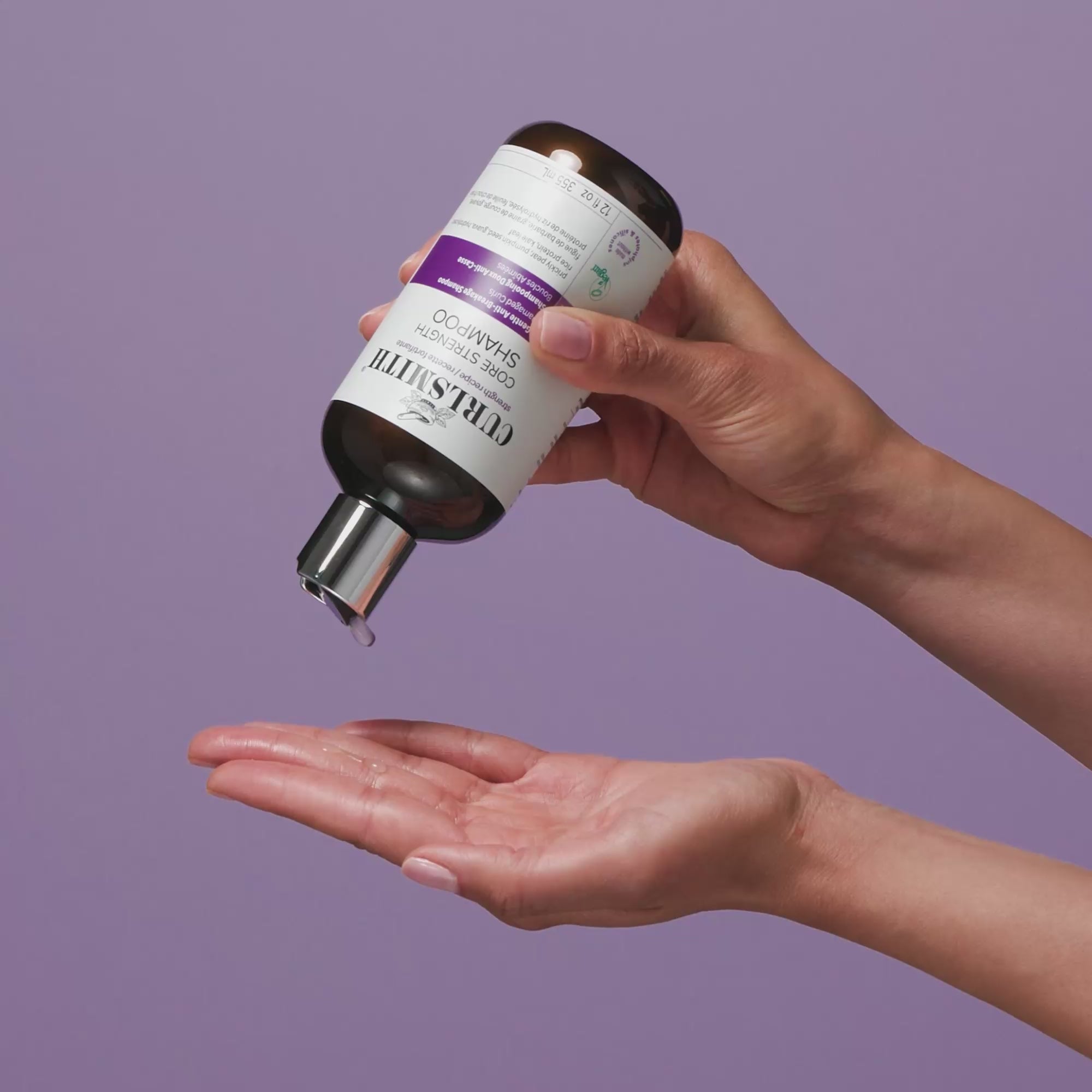 Person applying Curlsmith Core Strength Shampoo