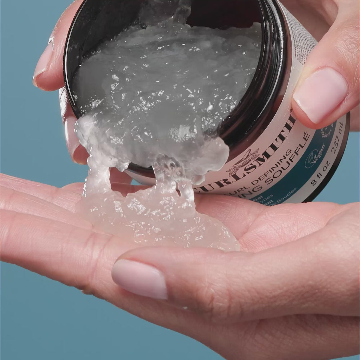 Hand holding Curlsmith Curl Defining Styling Souflee